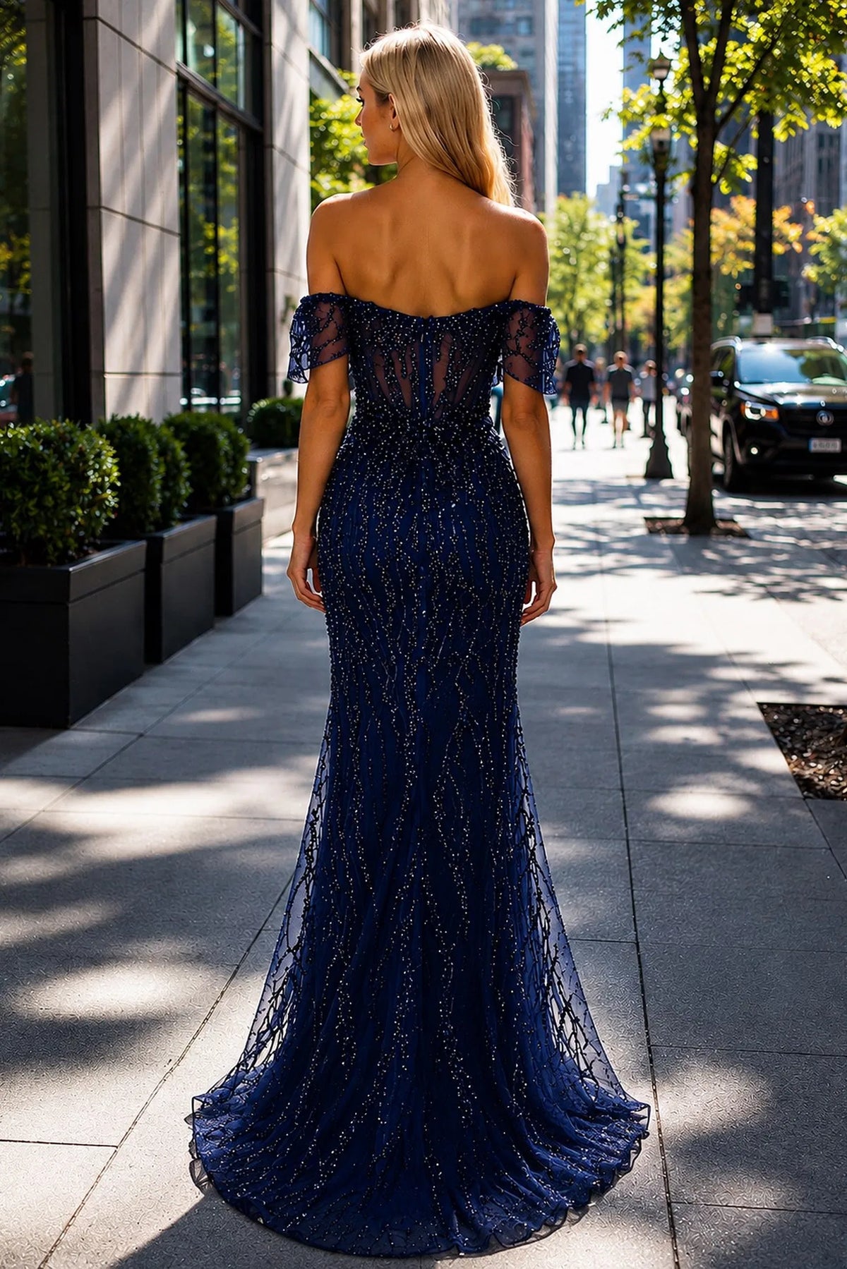 Back view of this Navy prom and evening dress highlights the fitted back and flowing hem.