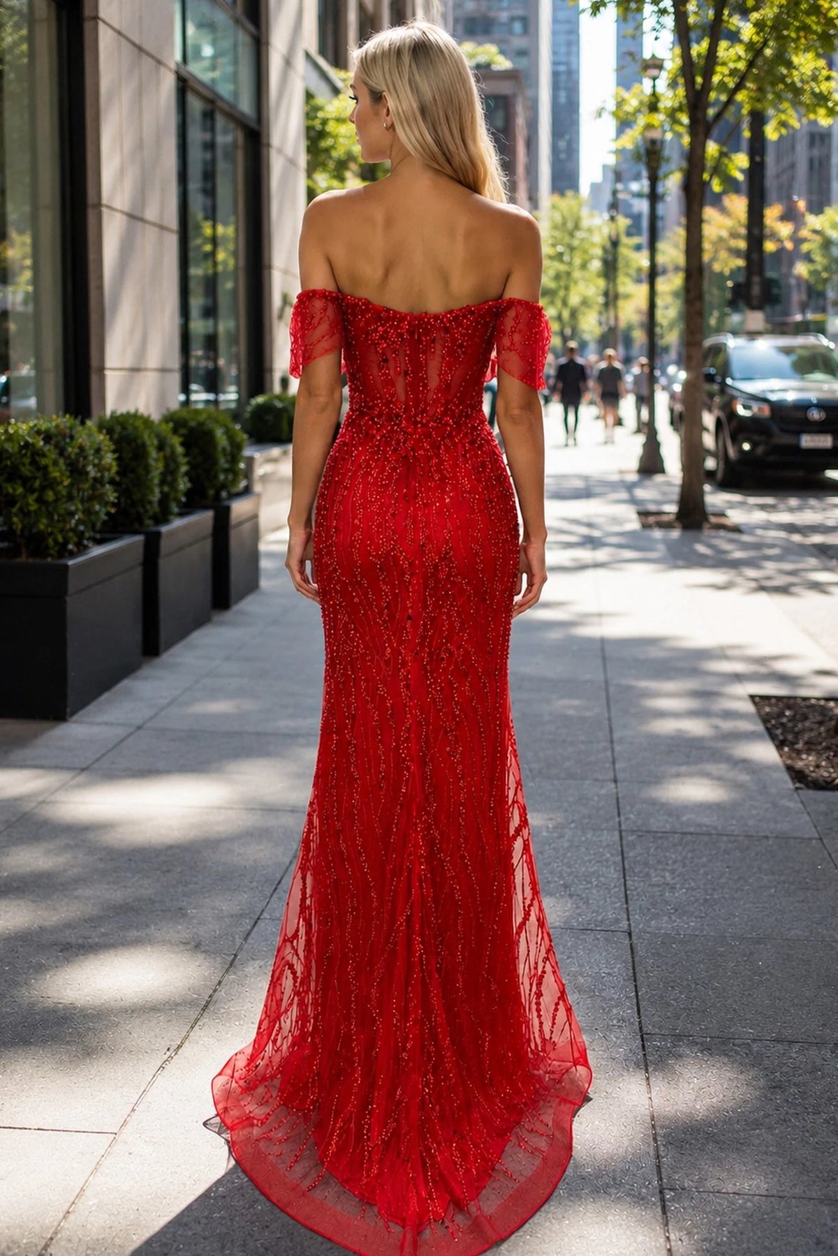 Back view of this Red prom and evening dress highlights the fitted back and flowing hem.