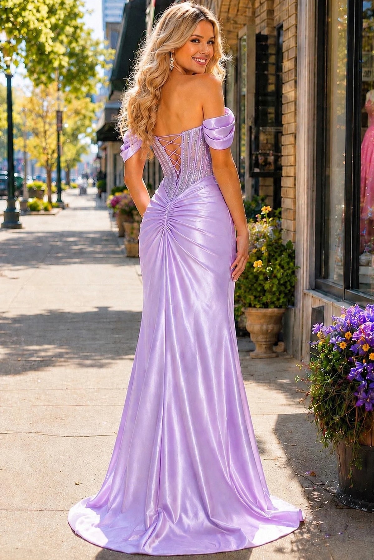 Back view of this Lilac prom and evening dress highlights the fitted back and flowing hem.