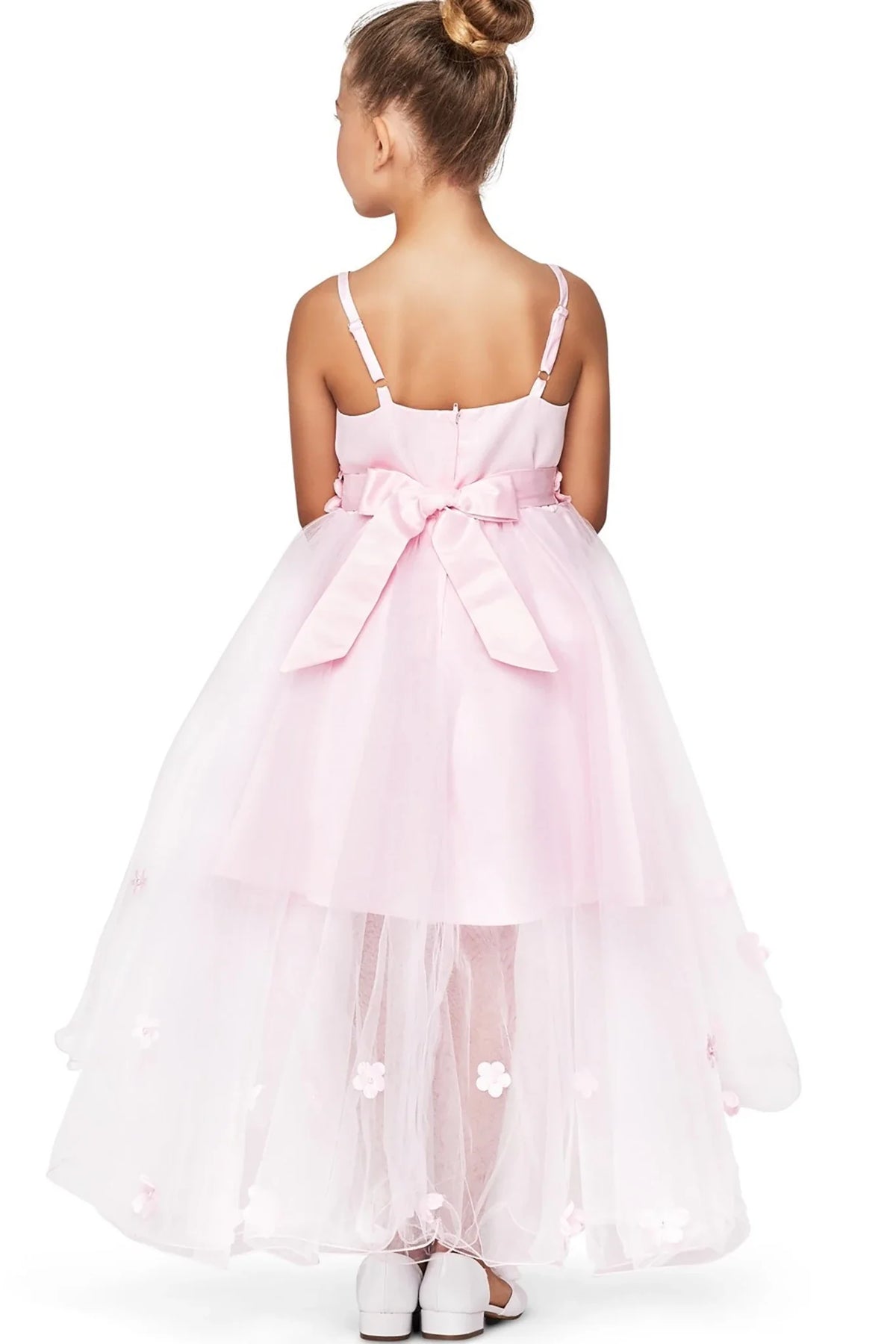 A pink flower girl dress with a large bow.