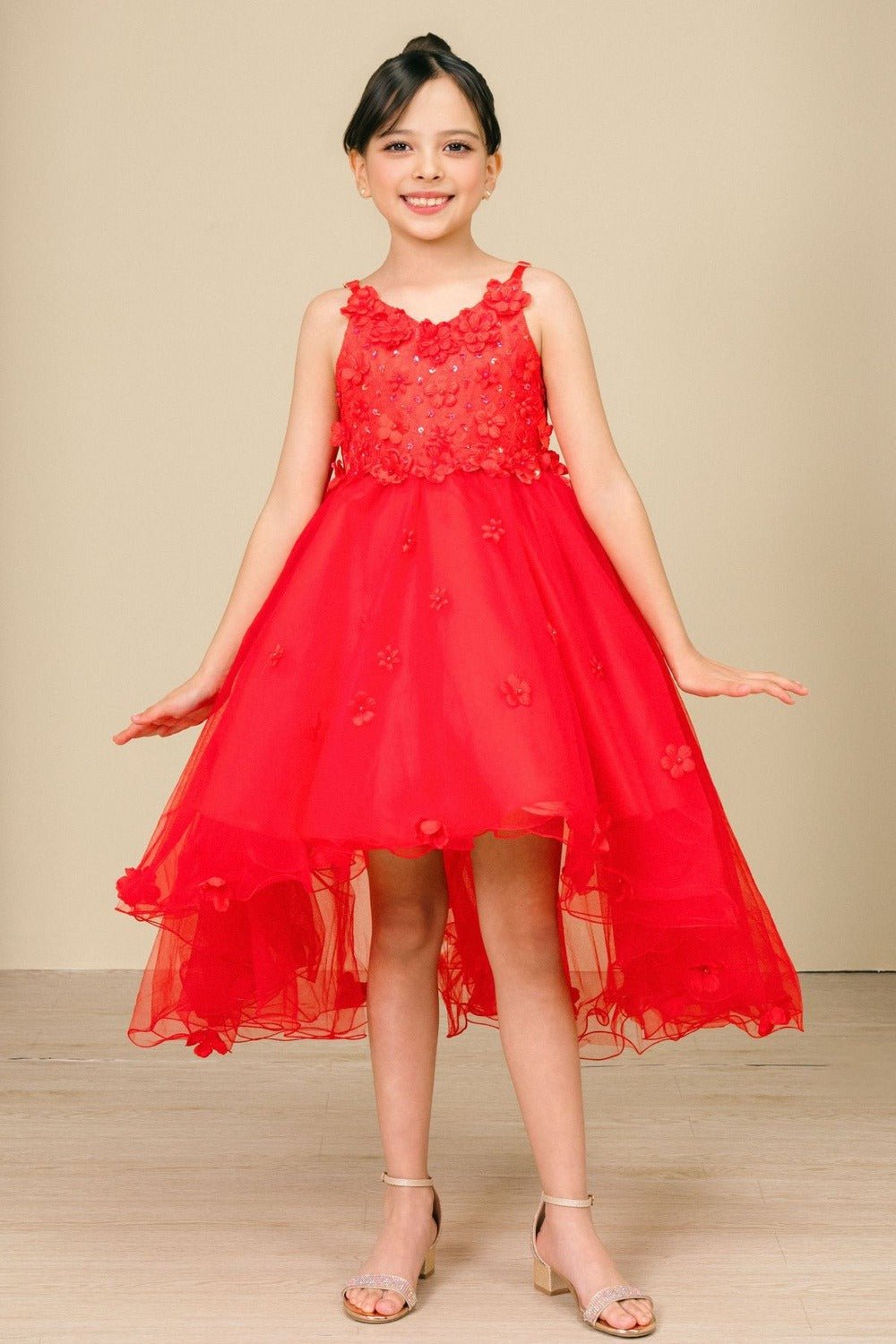 Front view of red high-low tulle flower girl dress with 3D floral appliqué bodice and cascading layered high-low skirt.