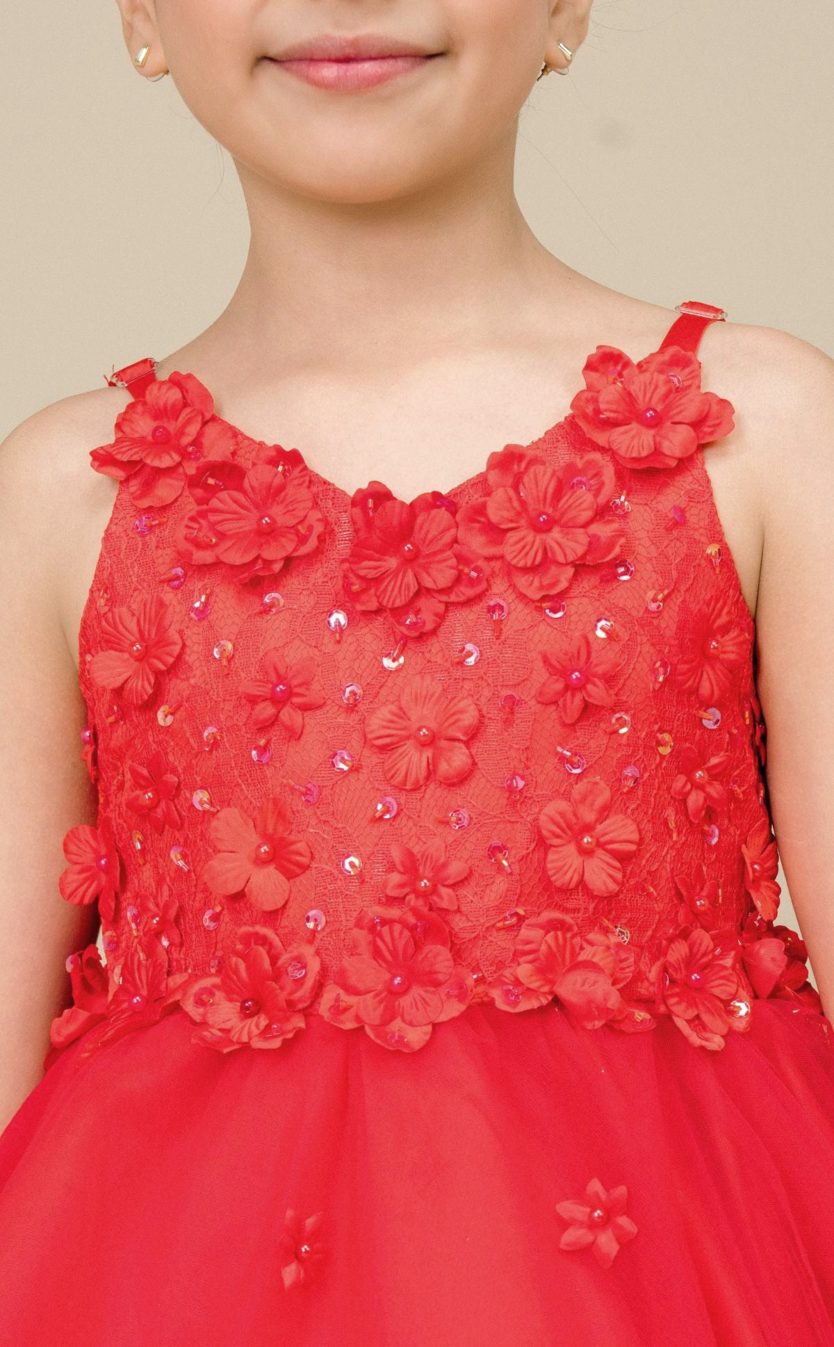 Close-up front-facing view of red high-low tulle flower girl dress with 3D floral appliqué bodice and elegant neckline.