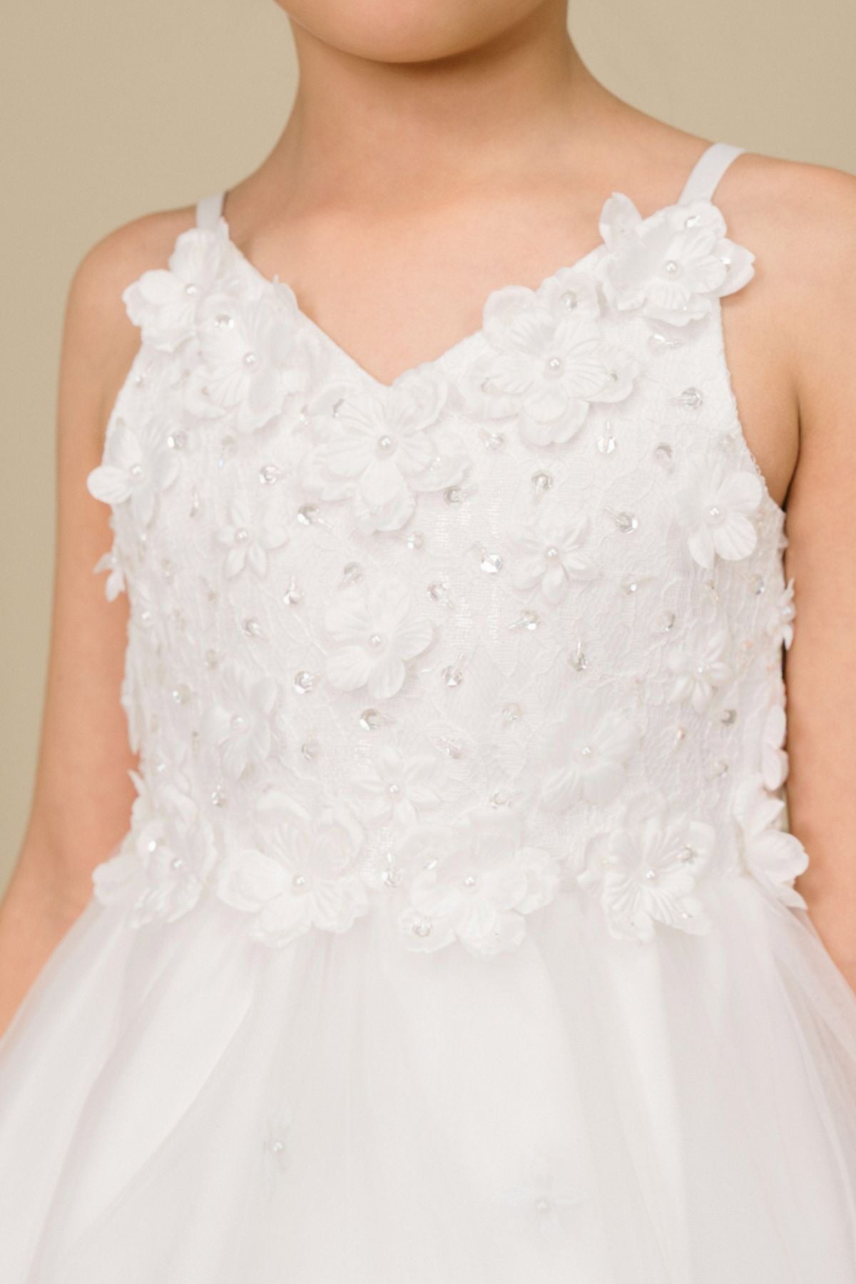 Close-up front-facing view of white high-low tulle flower girl dress with 3D floral appliqué bodice and elegant neckline.