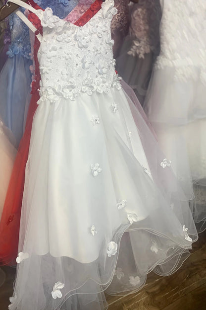 White floral dress on a hanger with a blurred background