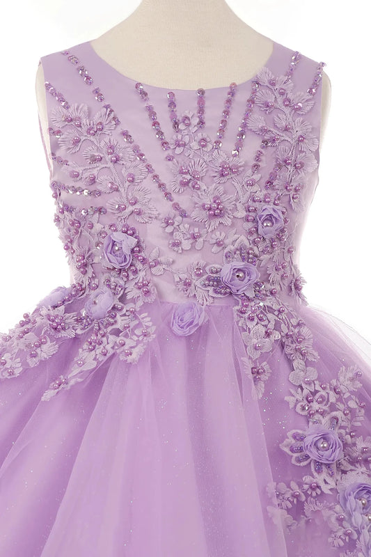 Young girl standing front-facing in lilac glitter tulle flower girl dress with 3D pearl-beaded floral appliqué bodice and layered skirt