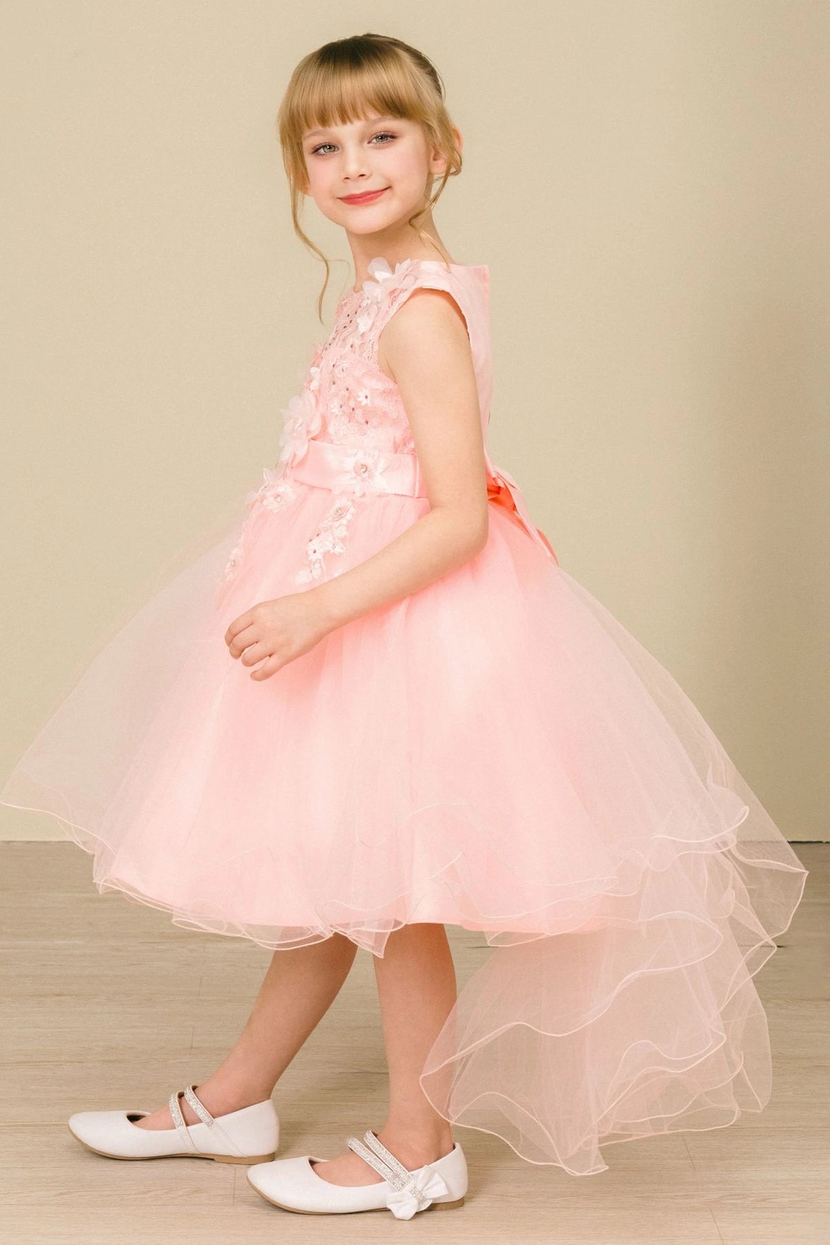 Details of the Blush flower girl dress include short front hem with a longer tulle back.