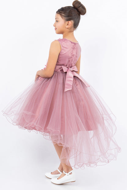 A Dusty Rose flower girl dress showing back satin bow above the longer tulle hem.