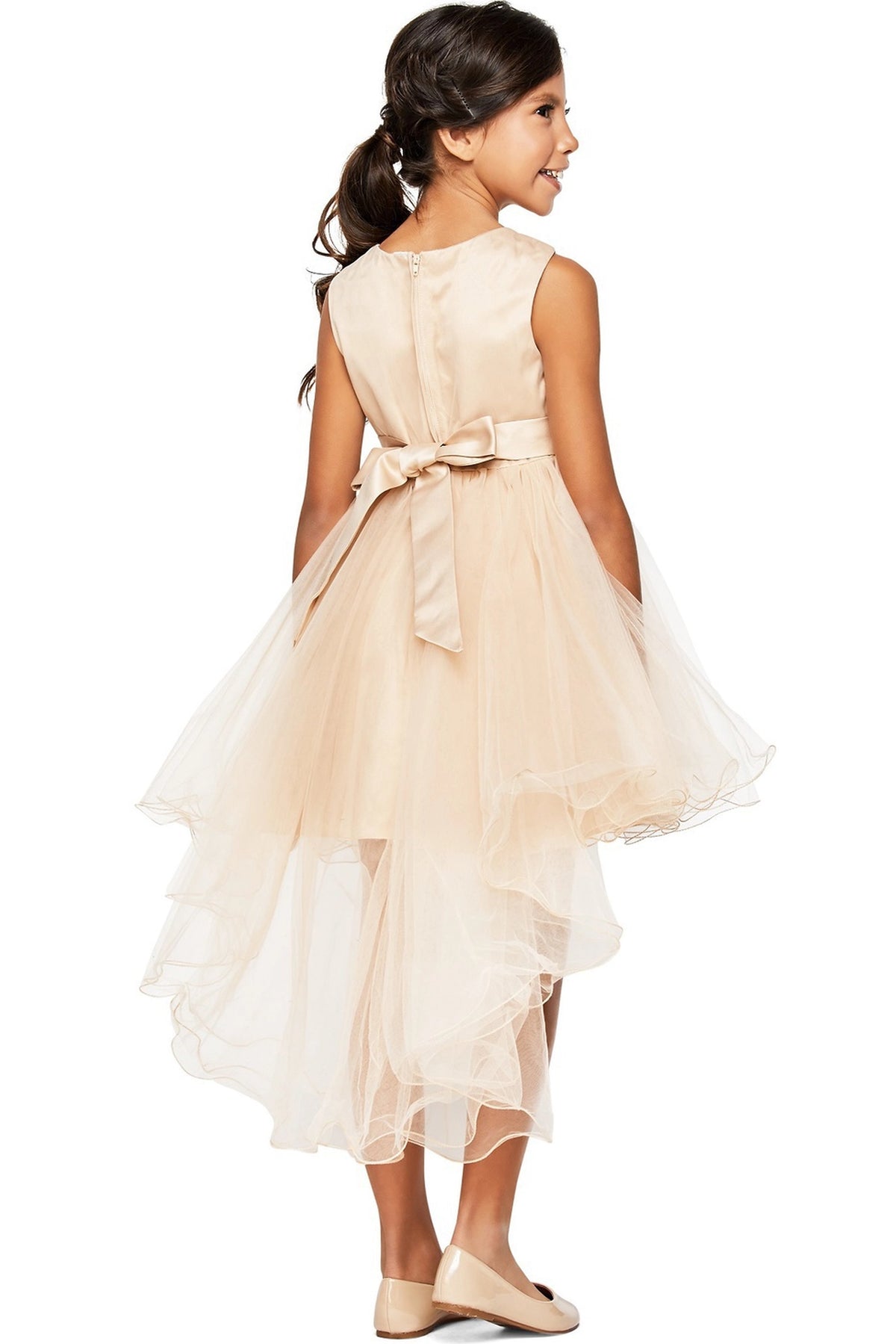 A Taupe flower girl dress showing satin sash bow above the long tulle back.