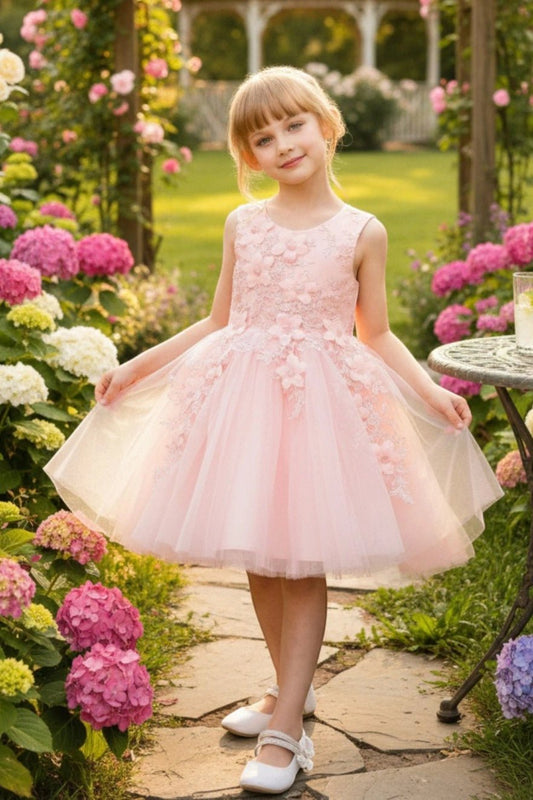 Shown in a front view, the Blush flower girl dress has sleeveless floral bodice and flared layered tulle skirt.
