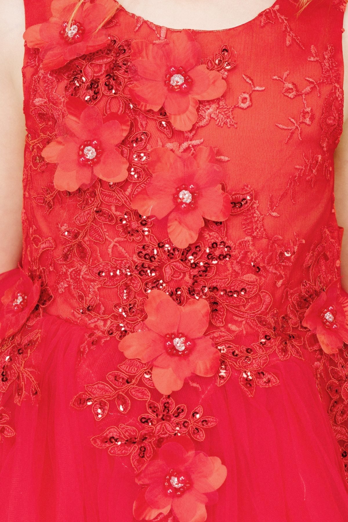 Close-up front-facing view of red sleeveless flower girl dress with 3D floral appliqué bodice and elegant neckline.