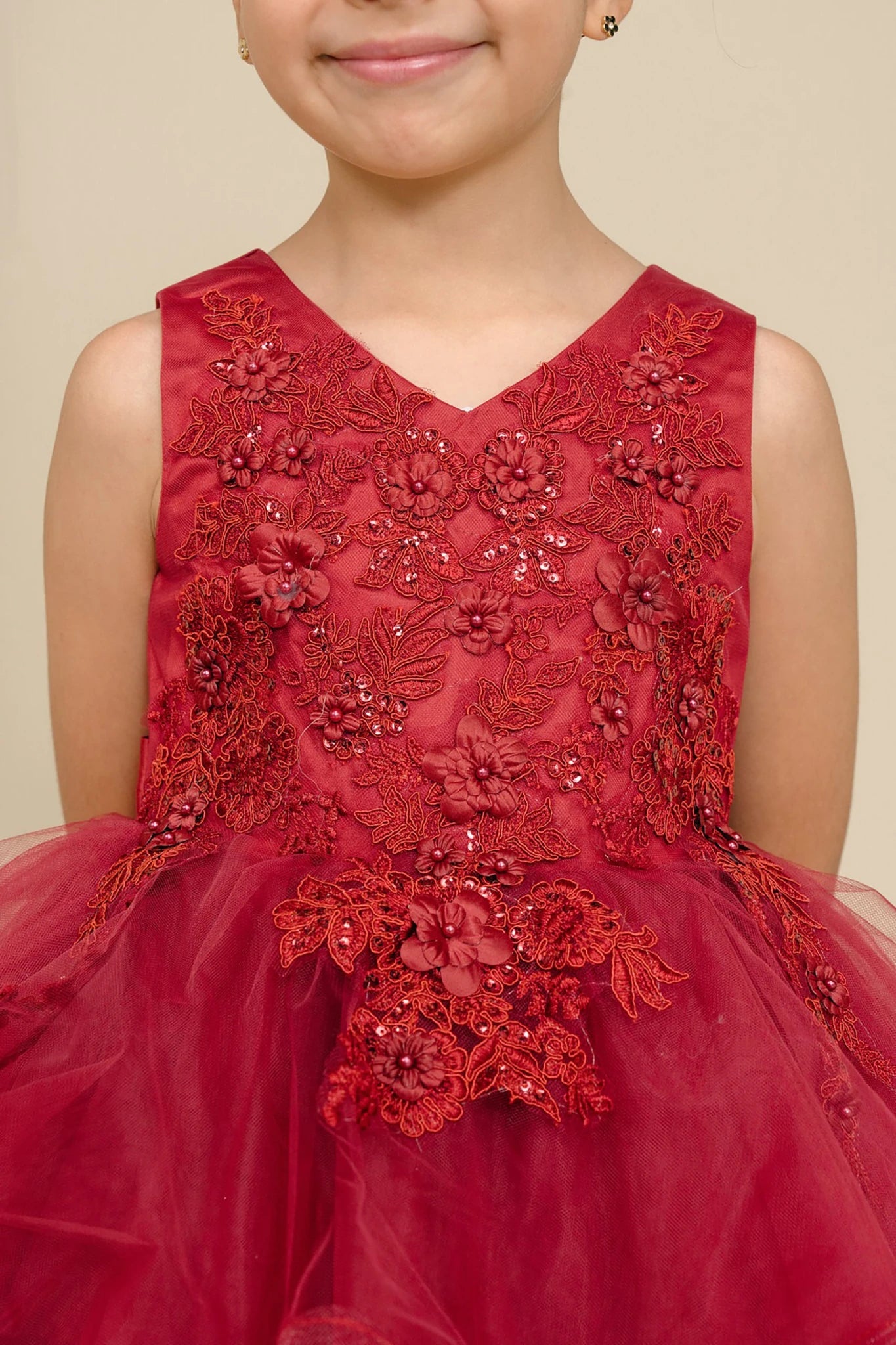A burgundy embroidered flower girl dress.