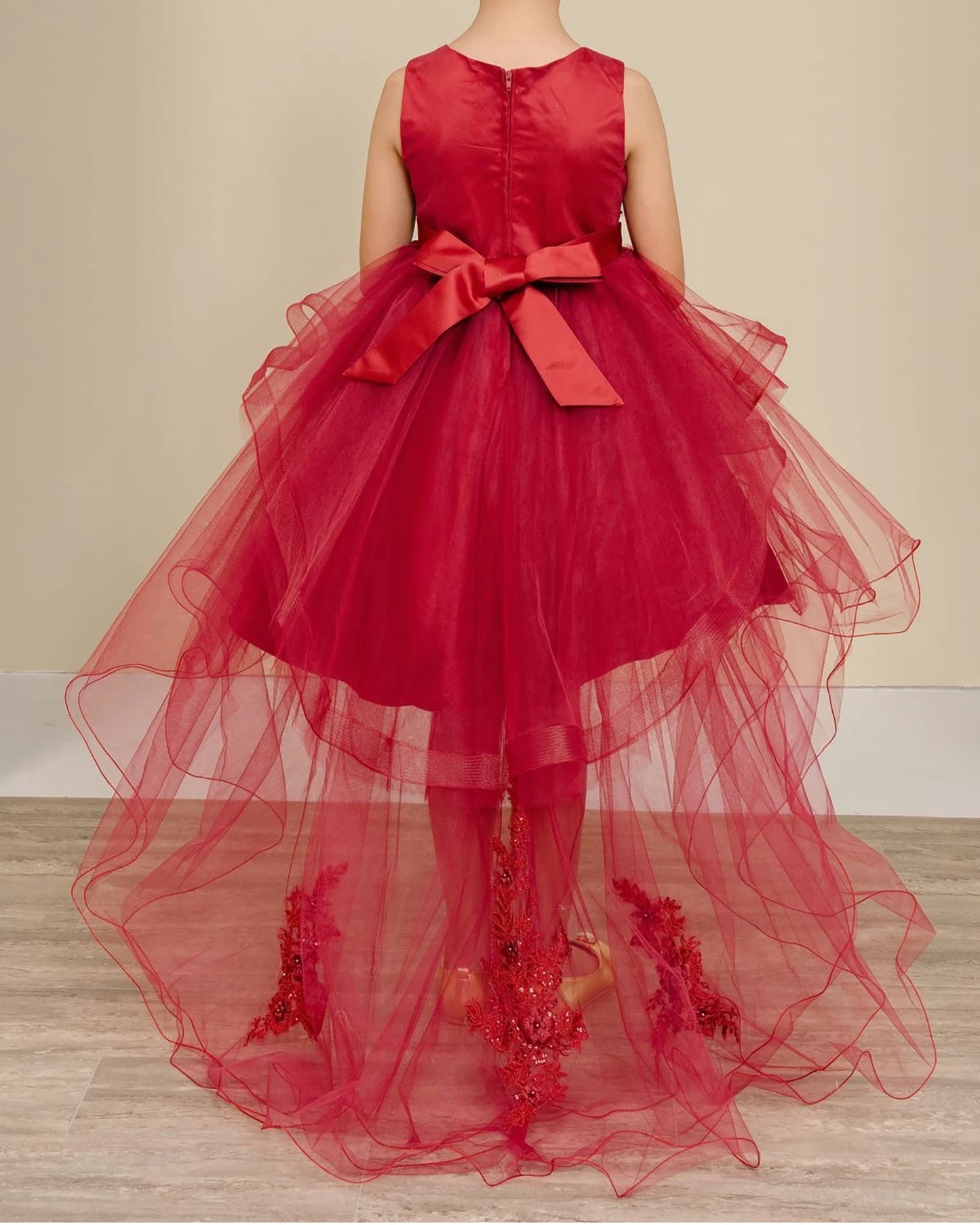 Burgundy flower girl dress with a large bow.