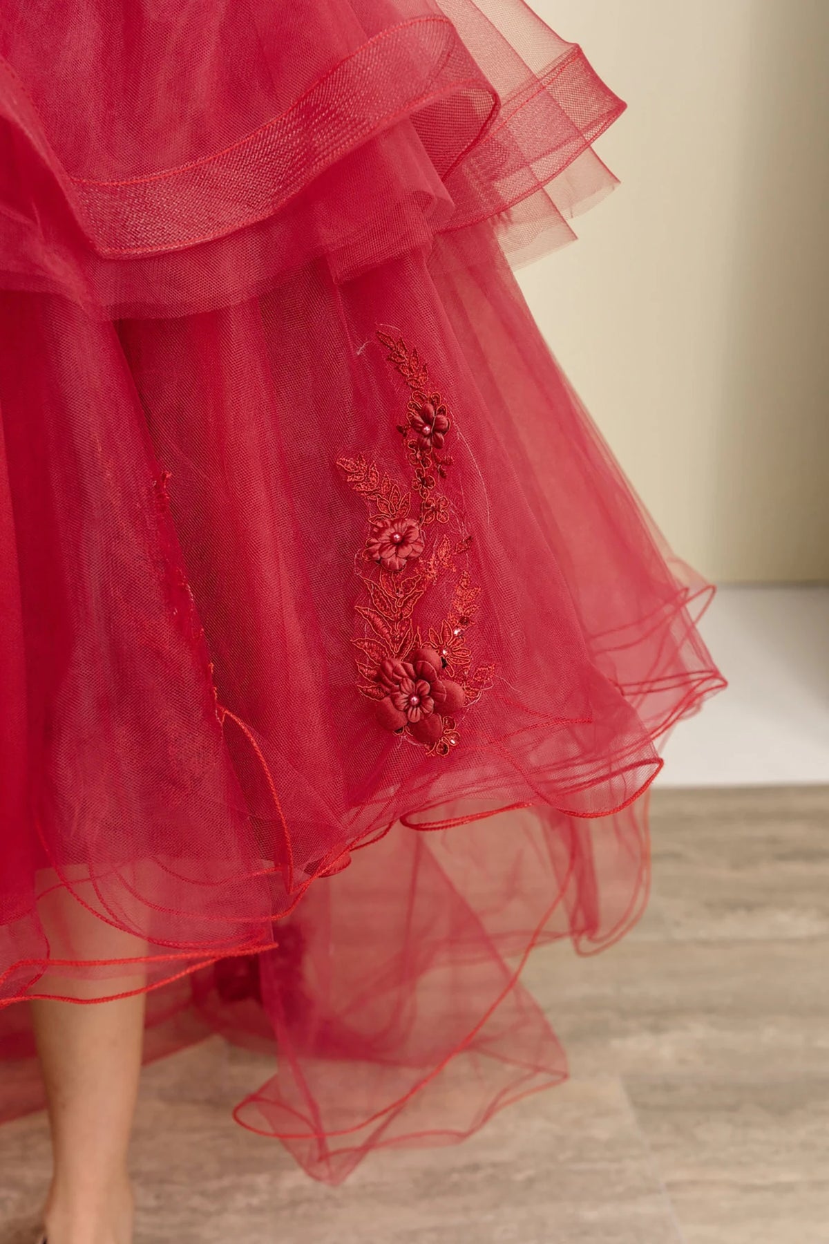 Burgundy flower girl dress with floral embellishments.