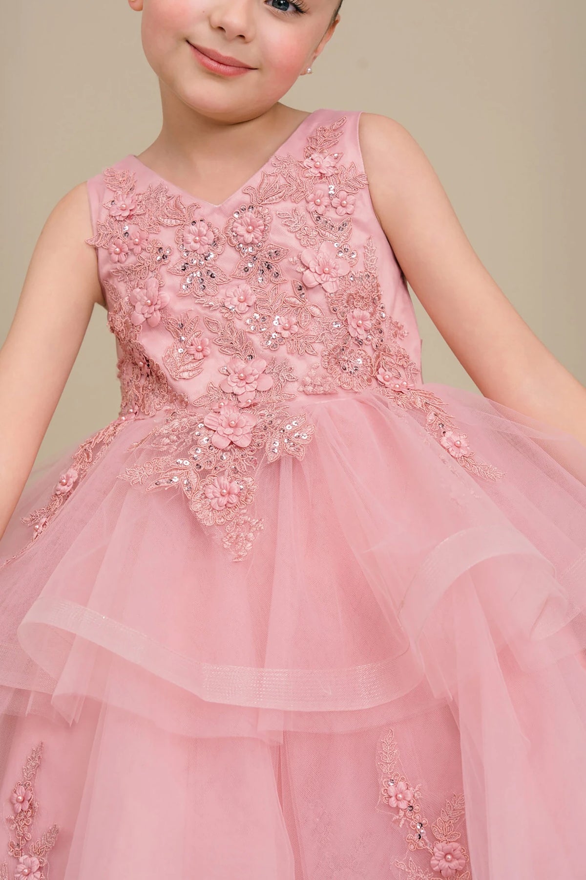 Dusty rose flower girl dress with floral embellishments.