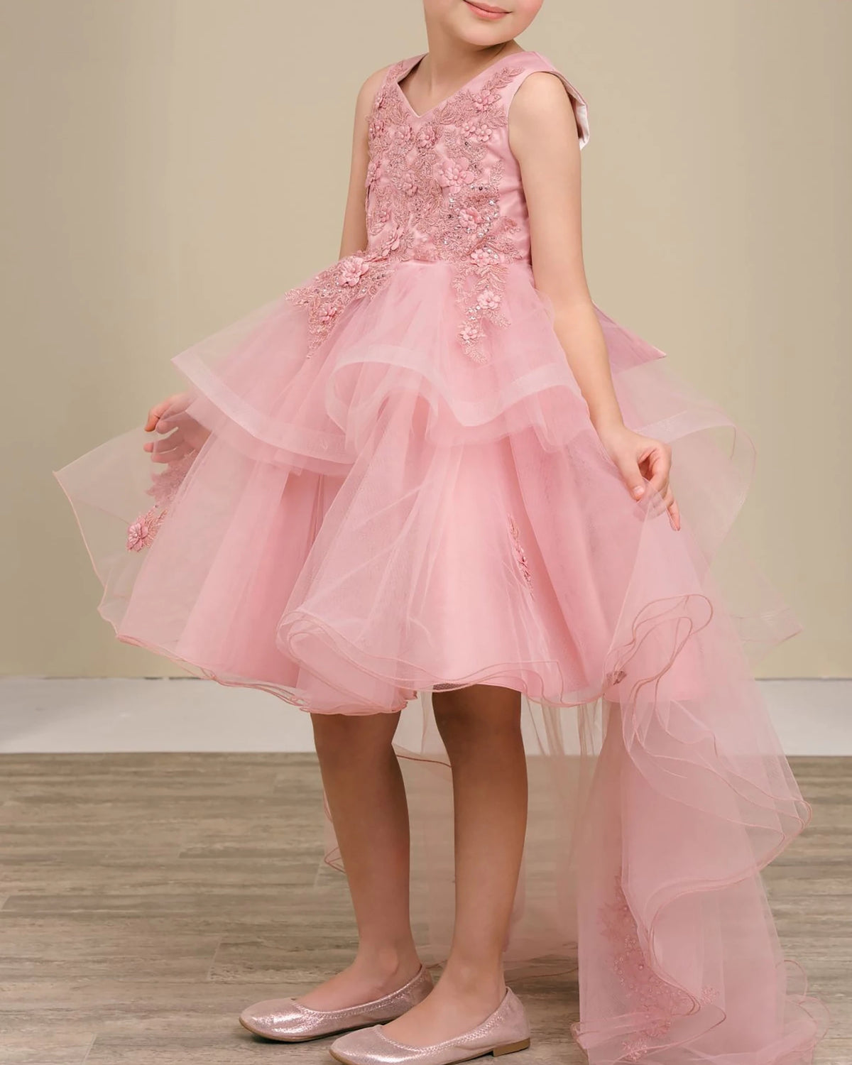 Dusty rose flower girl dress with floral embellishments.