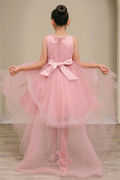 Decorative elements define dusty rose high low flower girl dress with a bow and floral details.