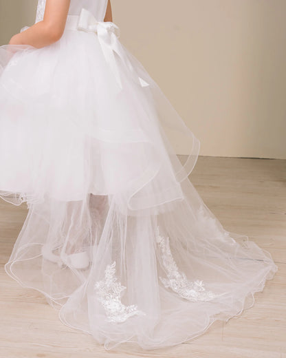 Textured details appear across white flower girl dress with lace details.