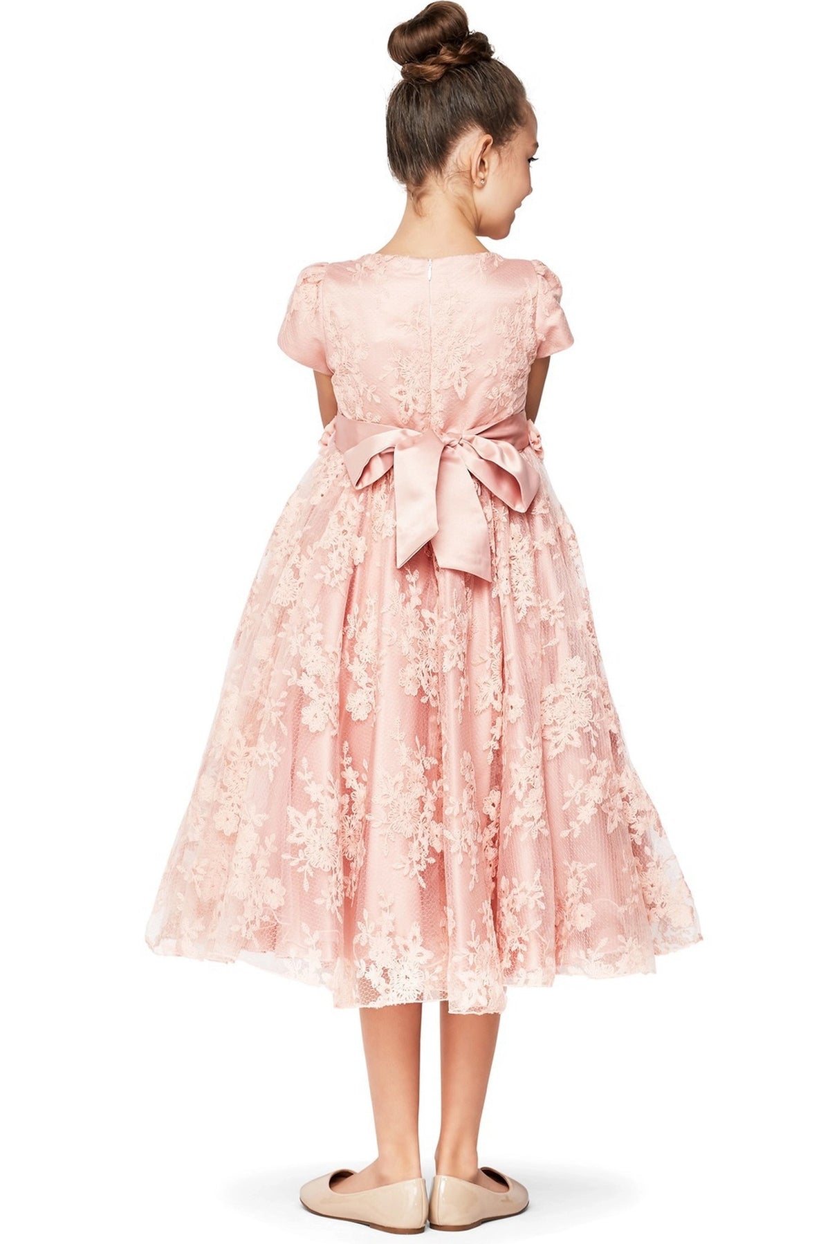 A Dusty Pink flower girl dress showing satin bow at the back of a floral lace dress.