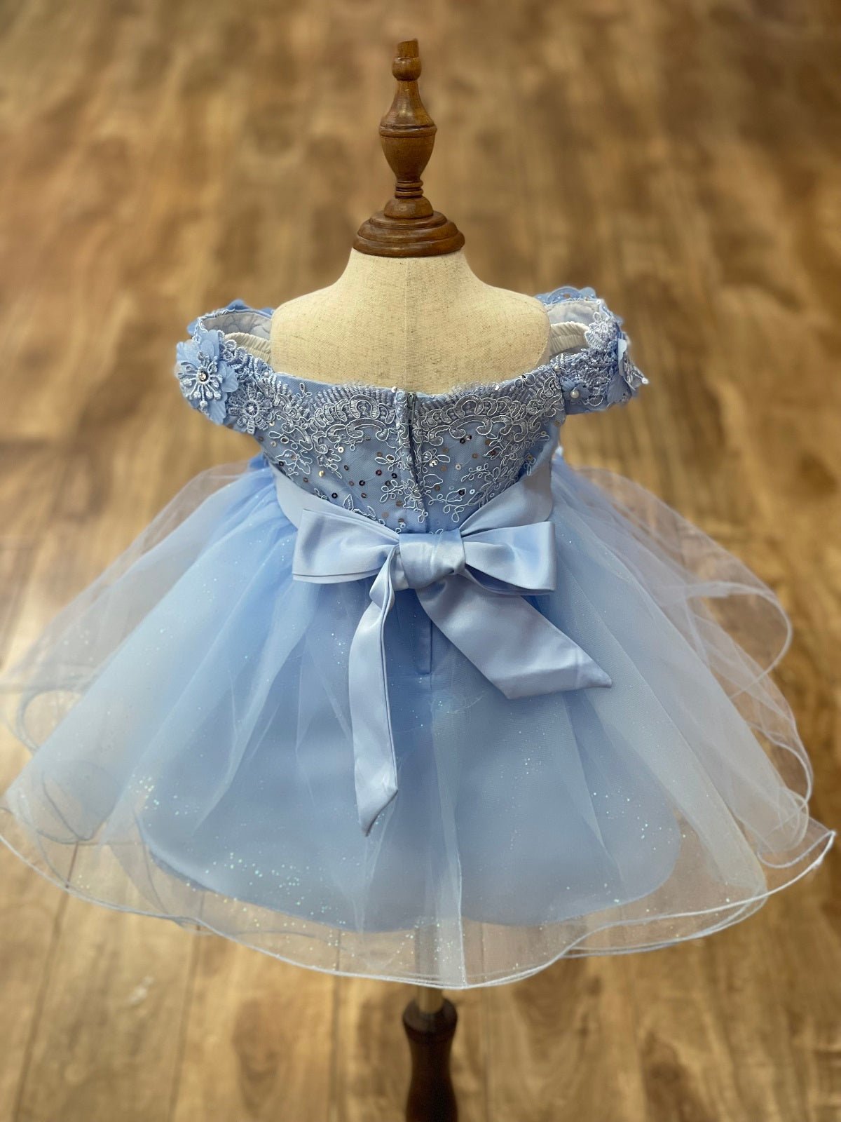 Sky blue flower girl dress back view highlighting flowing tulle skirt and elegant silhouette.