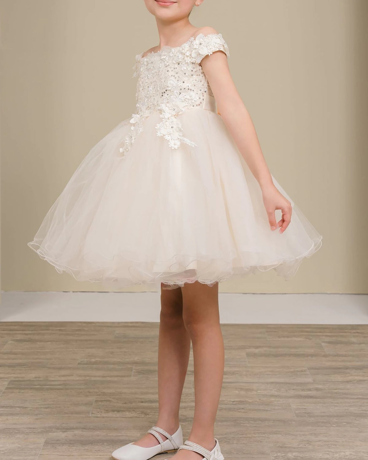 A champagne floral flower girl dress.
