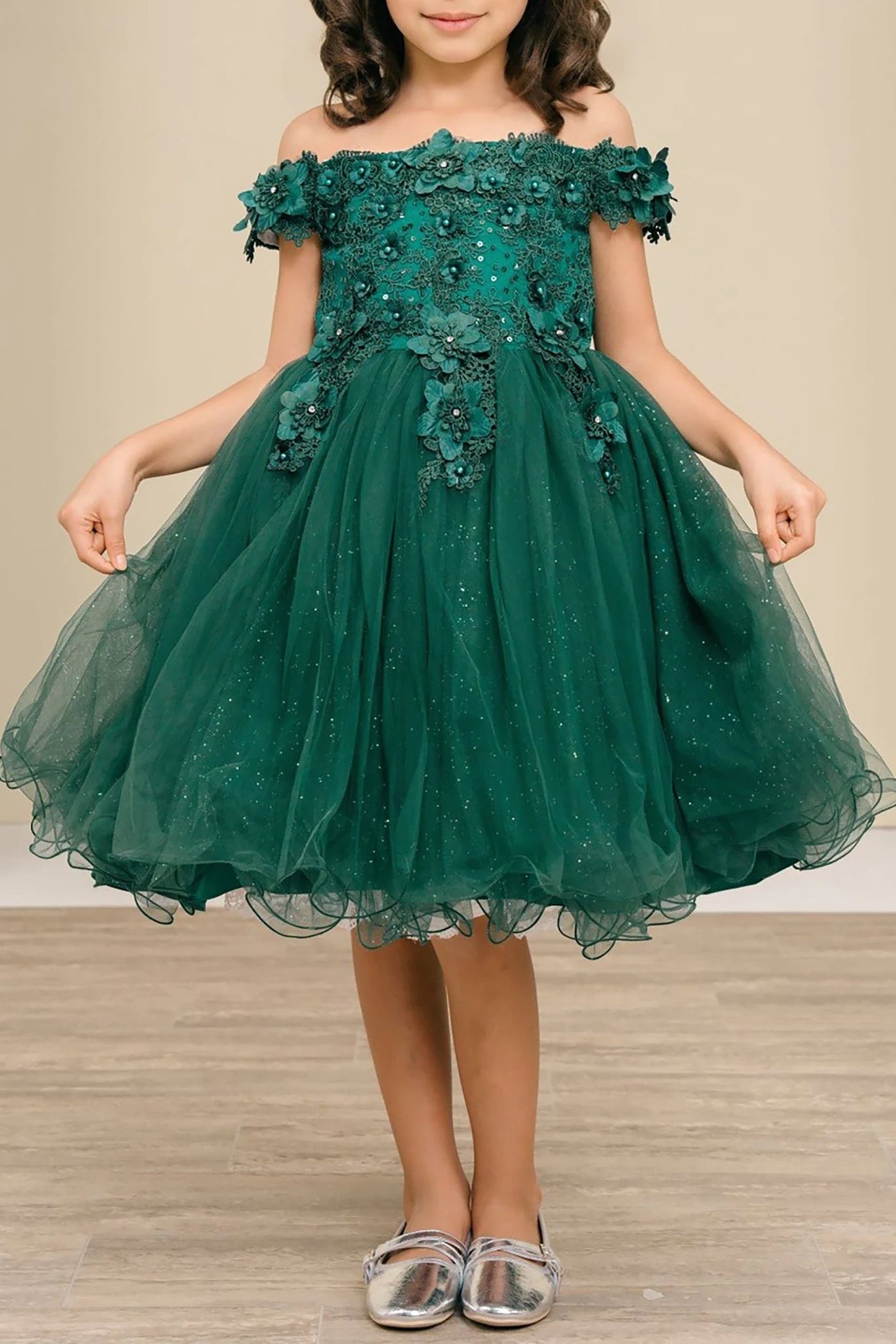 Front view of hunter green off-the-shoulder flower girl dress with 3D floral appliqué bodice, rhinestone embellishments, and glitter tulle layered skirt.