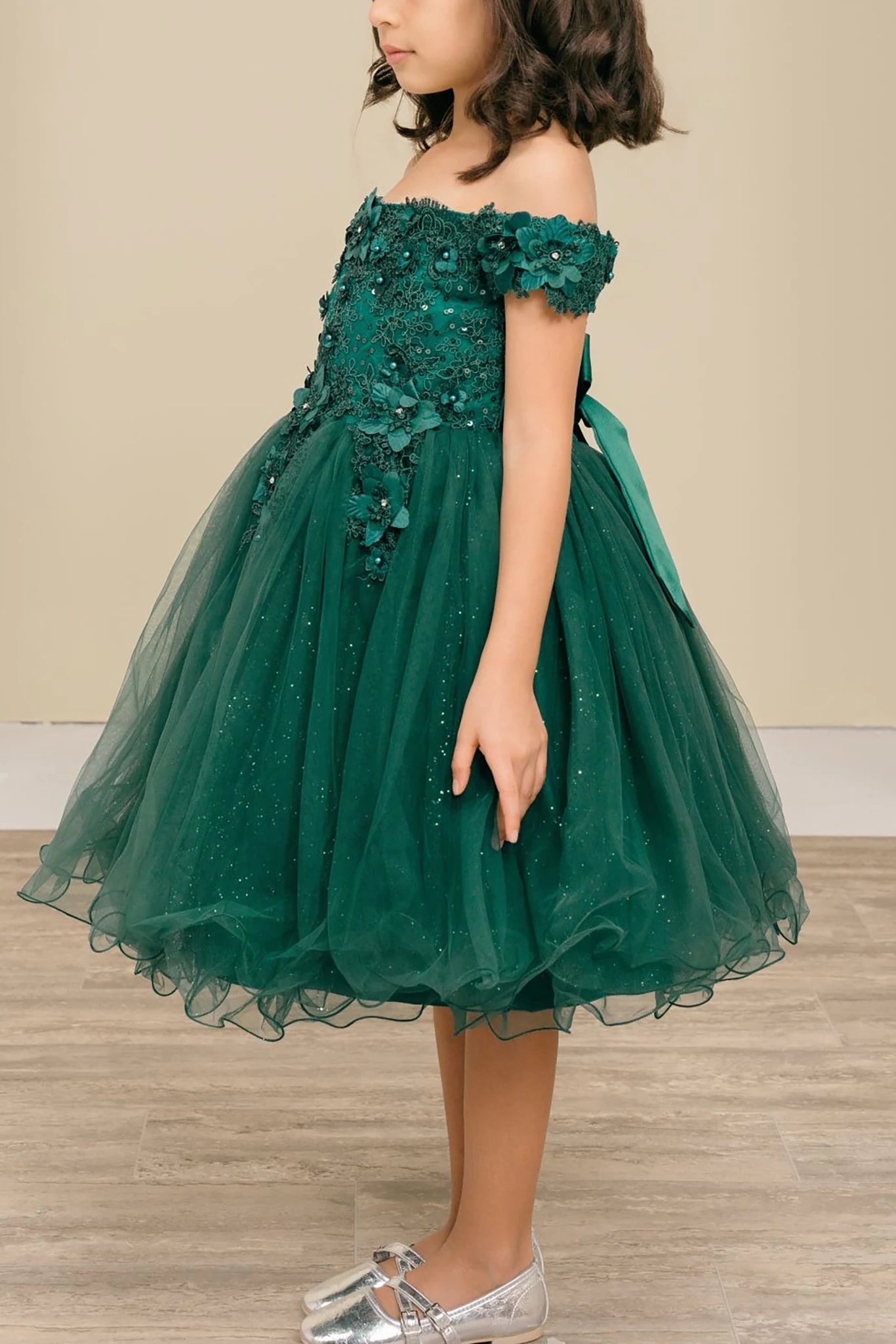Green off-shoulder flower girl dress with floral details.