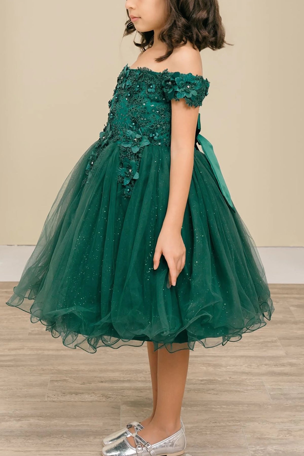 Green off-shoulder flower girl dress with floral details.