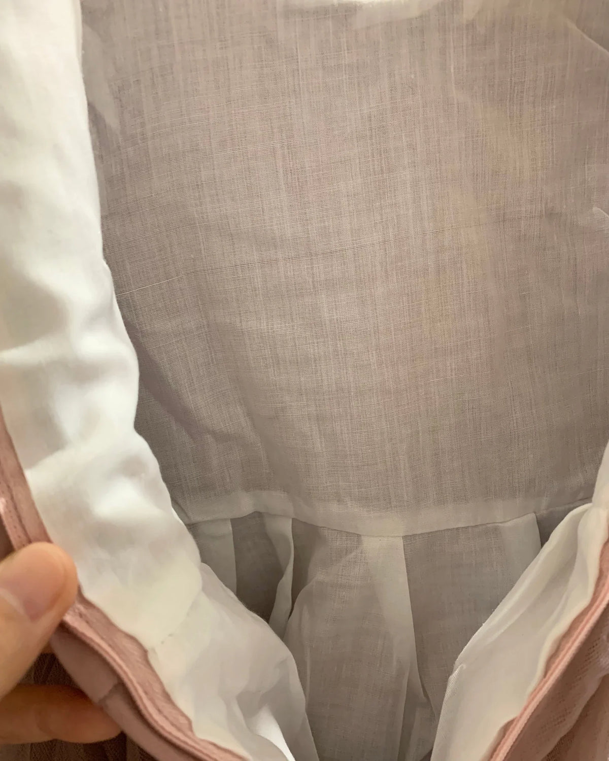 Close-up of a garment with a focus on the cotton lining. Flower girl dress.