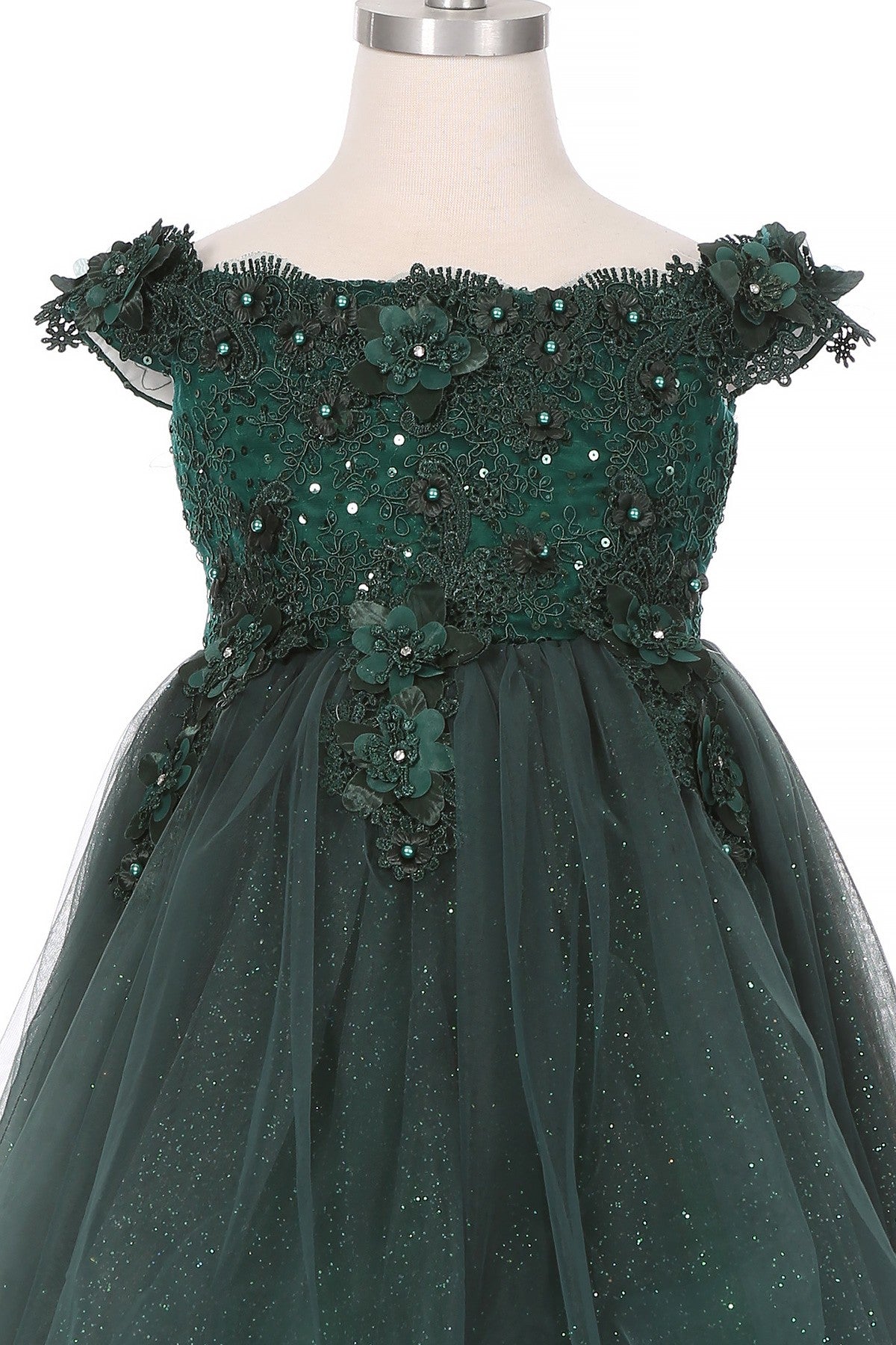 Close-up front view of hunter green flower girl dress showing floral applique and pearl detail.