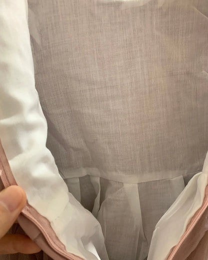 Close-up of a garment with a focus on the cotton lining. Flower girl dress.