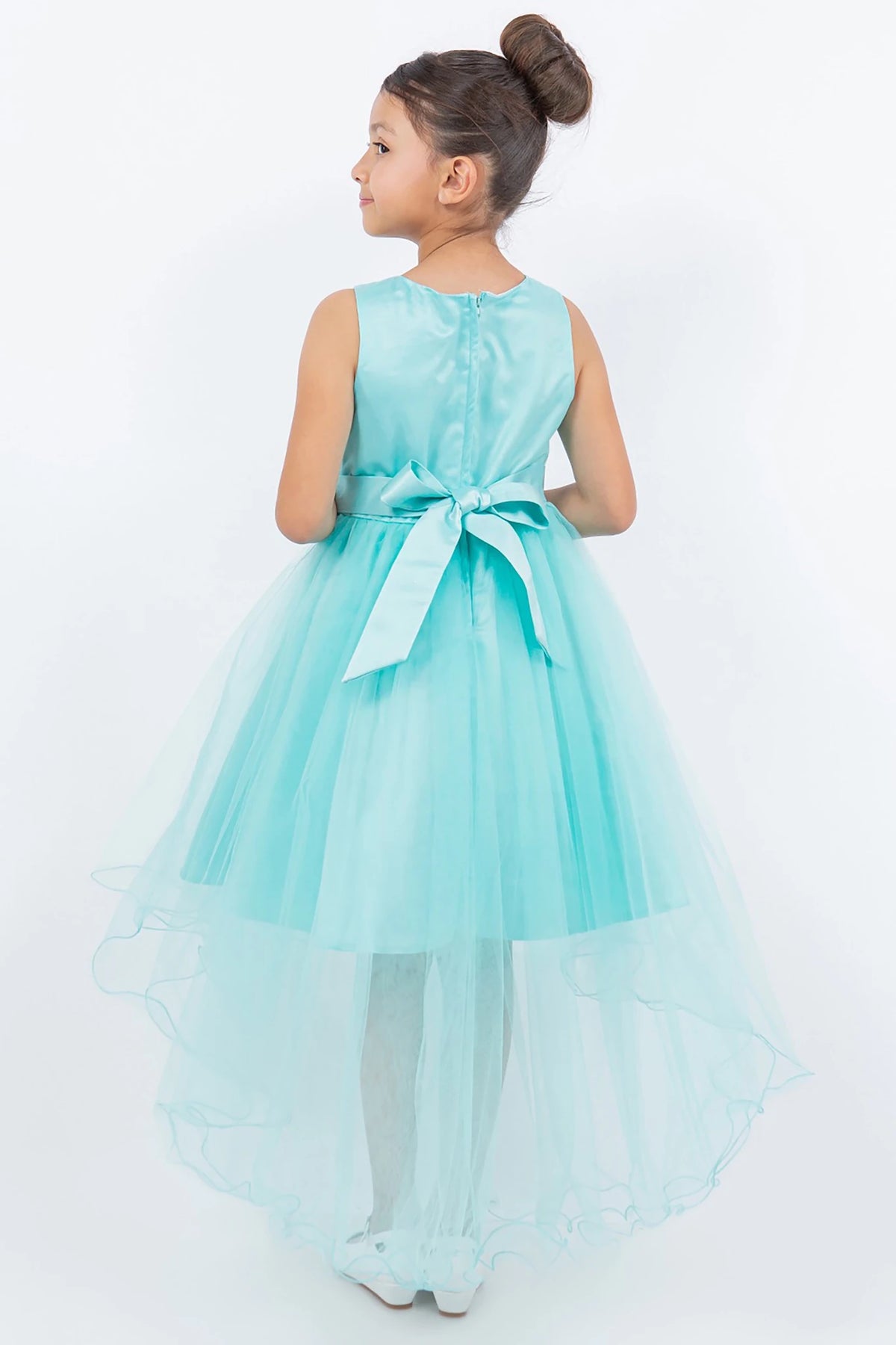 Side view of aqua blue sleeveless high-low tulle flower girl dress with lace detailing, pearl accents, rhinestone sparkle, and flowing layered skirt.