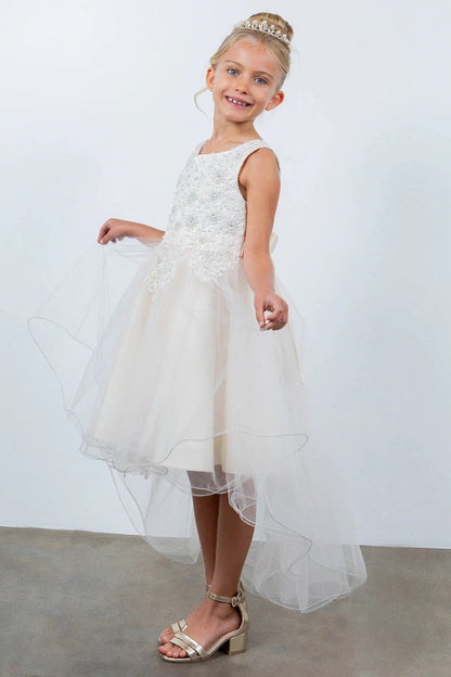 Shown in a angled view, the Champagne flower girl dress has sleeveless embellished bodice and layered high-low tulle skirt.