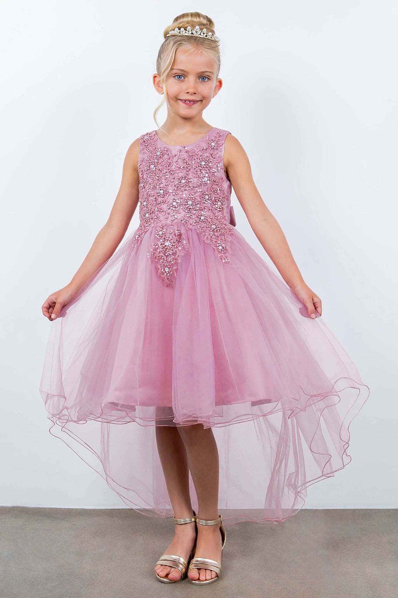 Front view of dusty rose sleeveless high-low tulle flower girl dress with lace bodice, pearl trim, rhinestone embellishments, and layered skirt.
