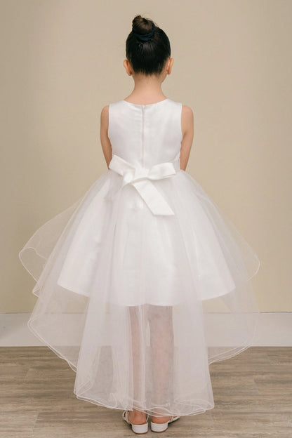 Shown in a back view, the White flower girl dress has satin bow and layered high-low tulle skirt.