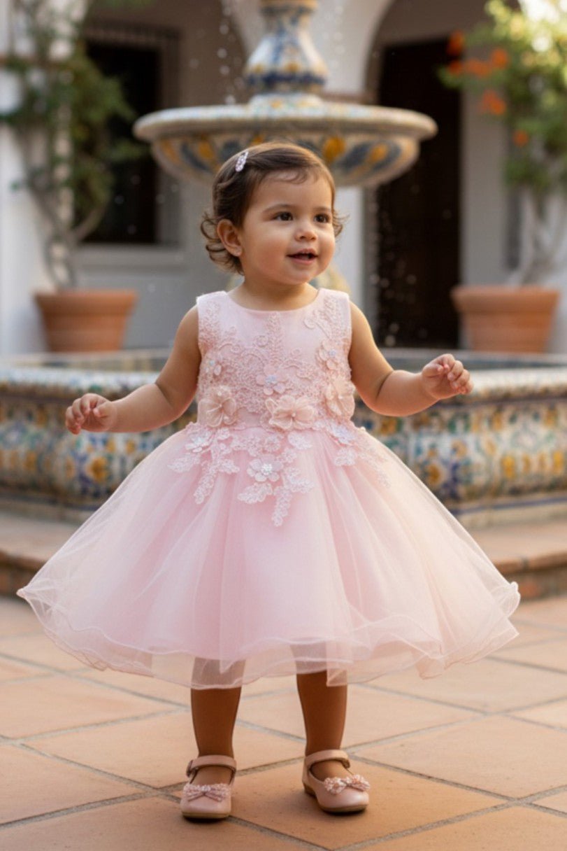 Blush flower girl Dress Front View With Cap Sleeves And Layered Tulle Skirt.