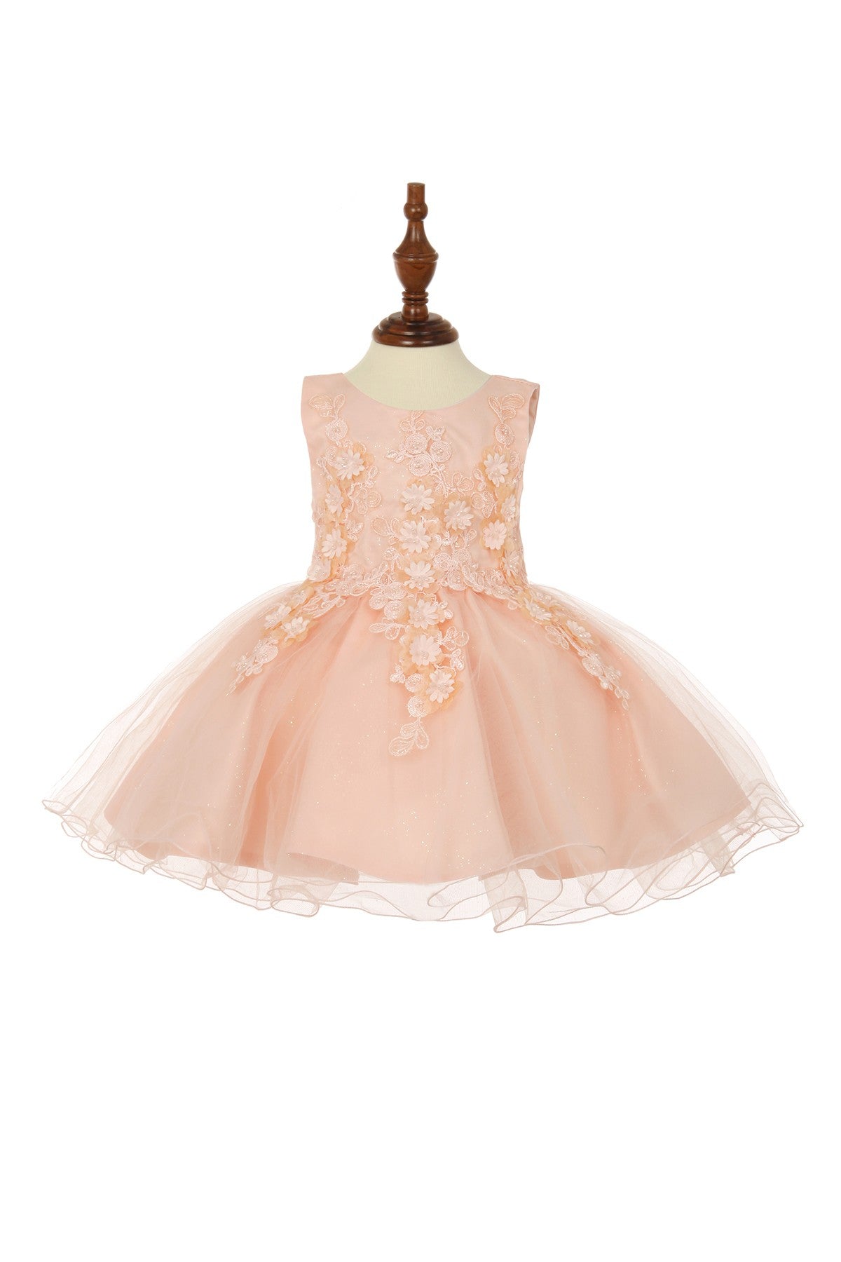Close-up front view of blush flower girl dress showing bodice detail and soft tulle texture.