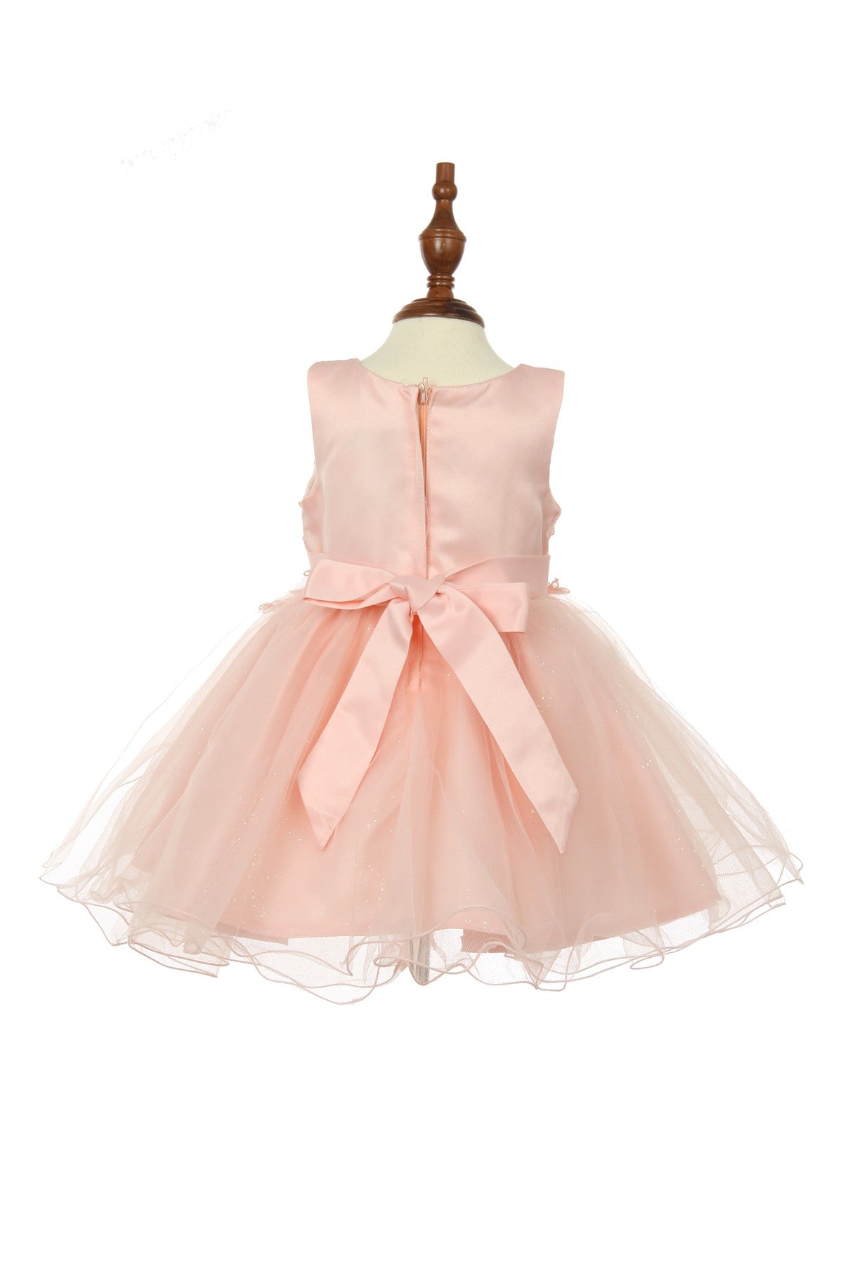 Blush flower girl Dress Front View With Cap Sleeves And Layered Tulle Skirt.