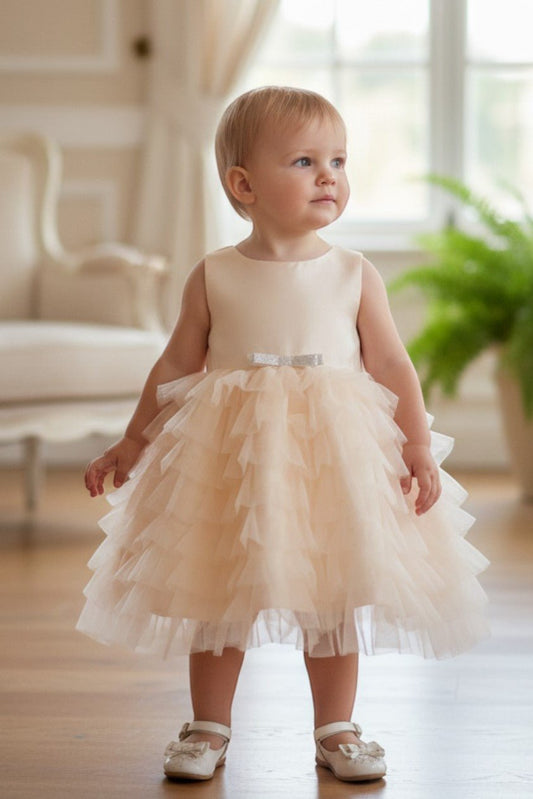 Kid Wearing Champagne Flower Girl Dress Front View With Cap Sleeves And Layered Tulle Skirt