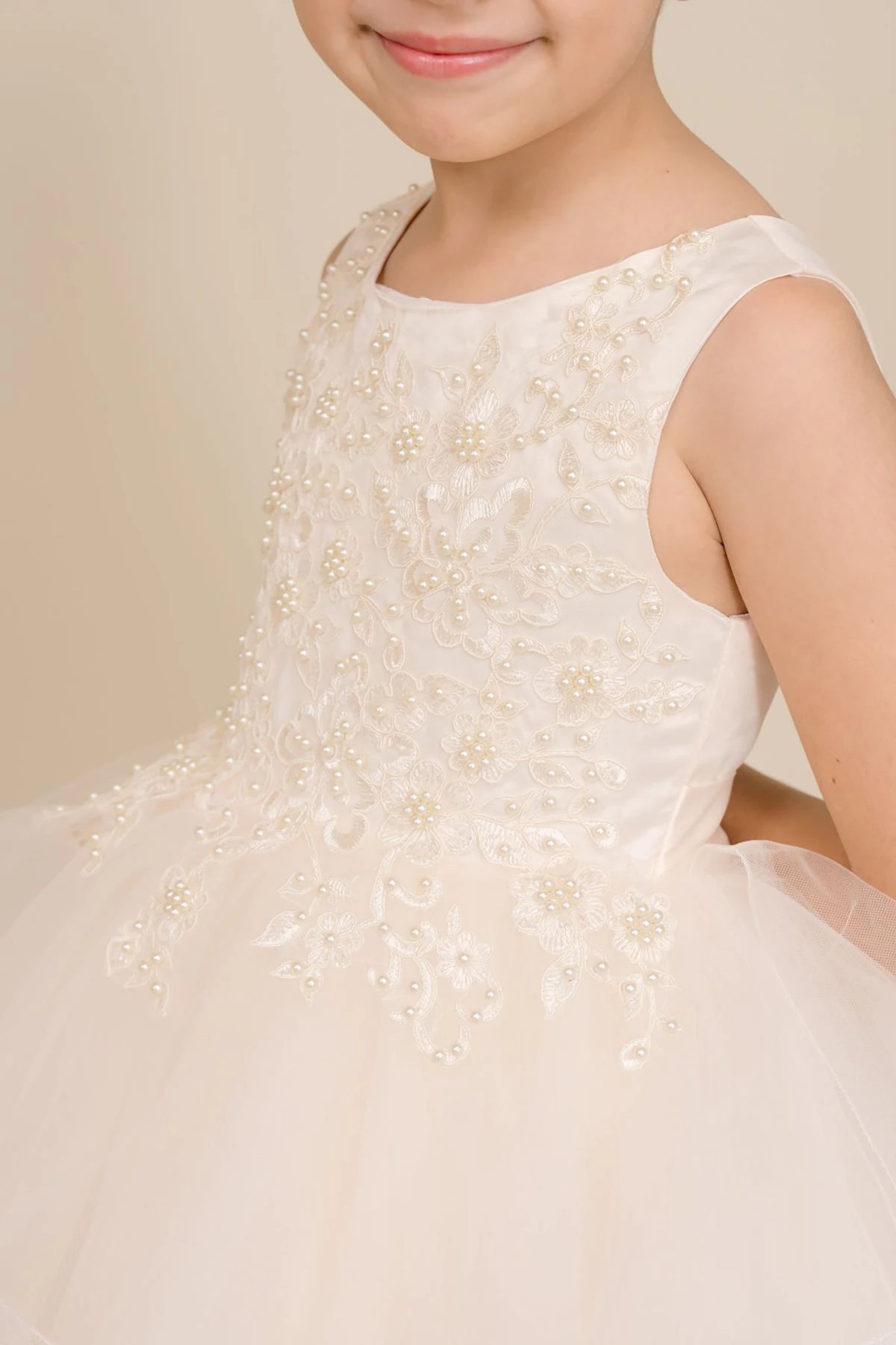 Champagne floral flower girl dress with a close-up of a it.
