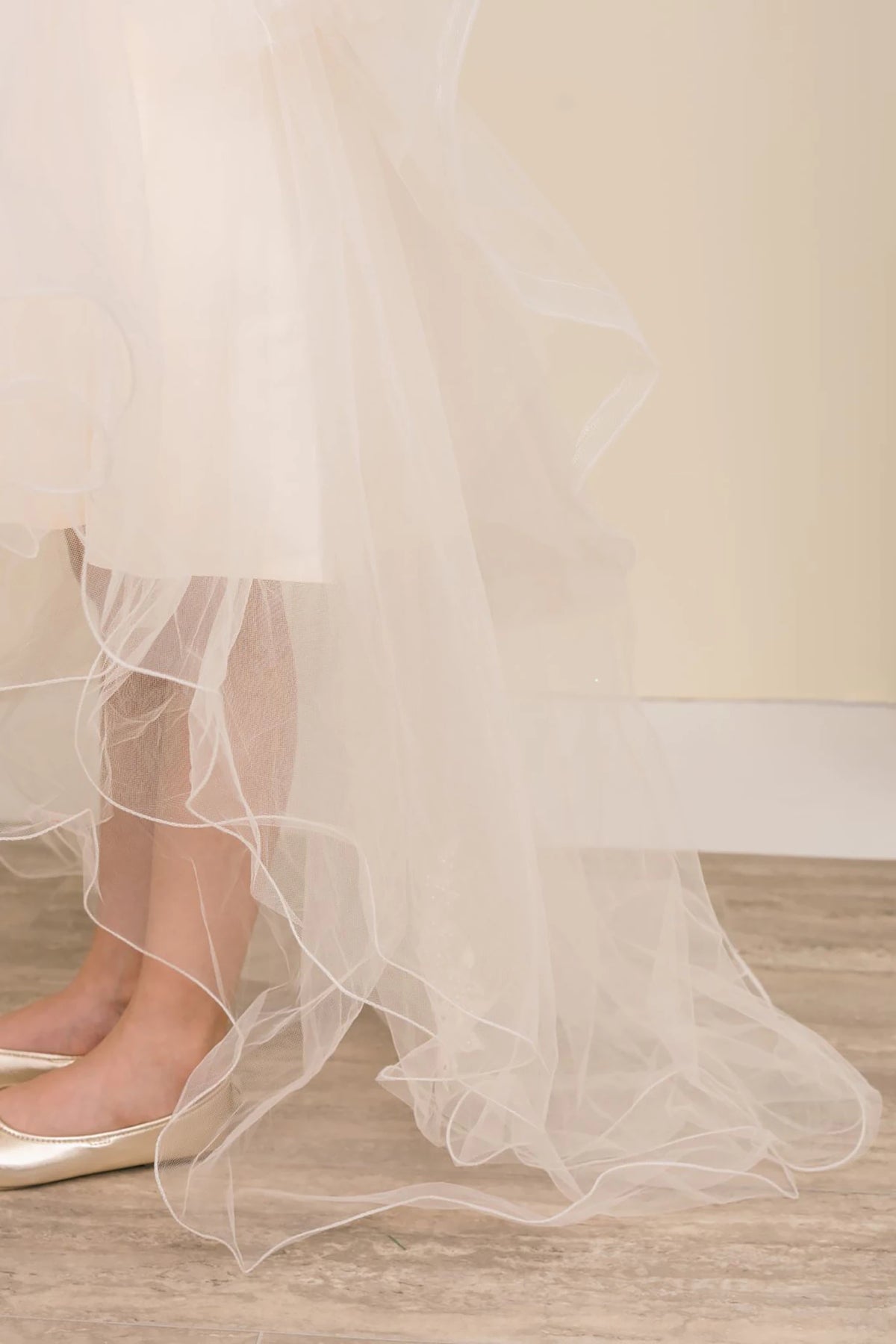 Close-up of a champagne tulle skirt. Flower girl dress.