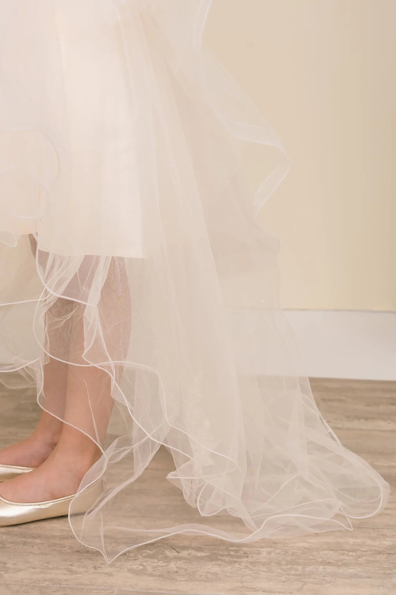 Close-up of a champagne tulle skirt. Flower girl dress.