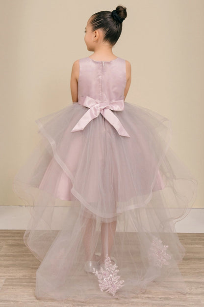 Shown in a back view, the Mauve flower girl dress has satin bow and sheer tulle skirt with lace train appliques.