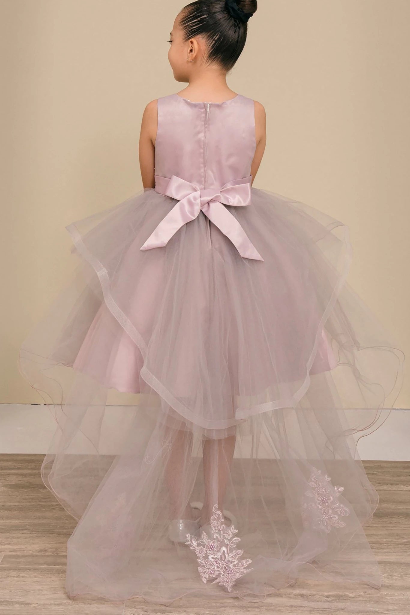 A Mauve floral flower girl dress with a bow.