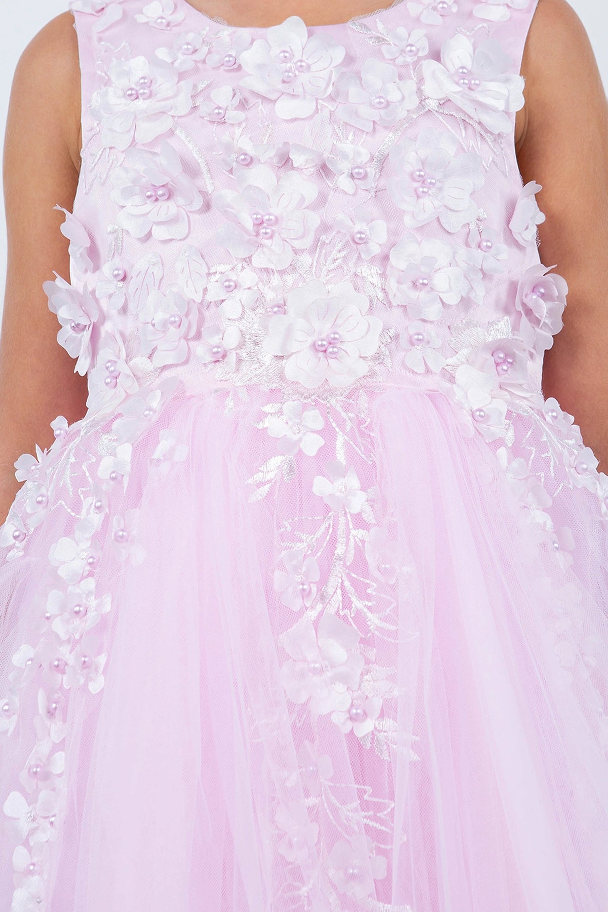 Detailed by three-dimensional flowers on the bodice, the Pink kids party dress reveals its construction.