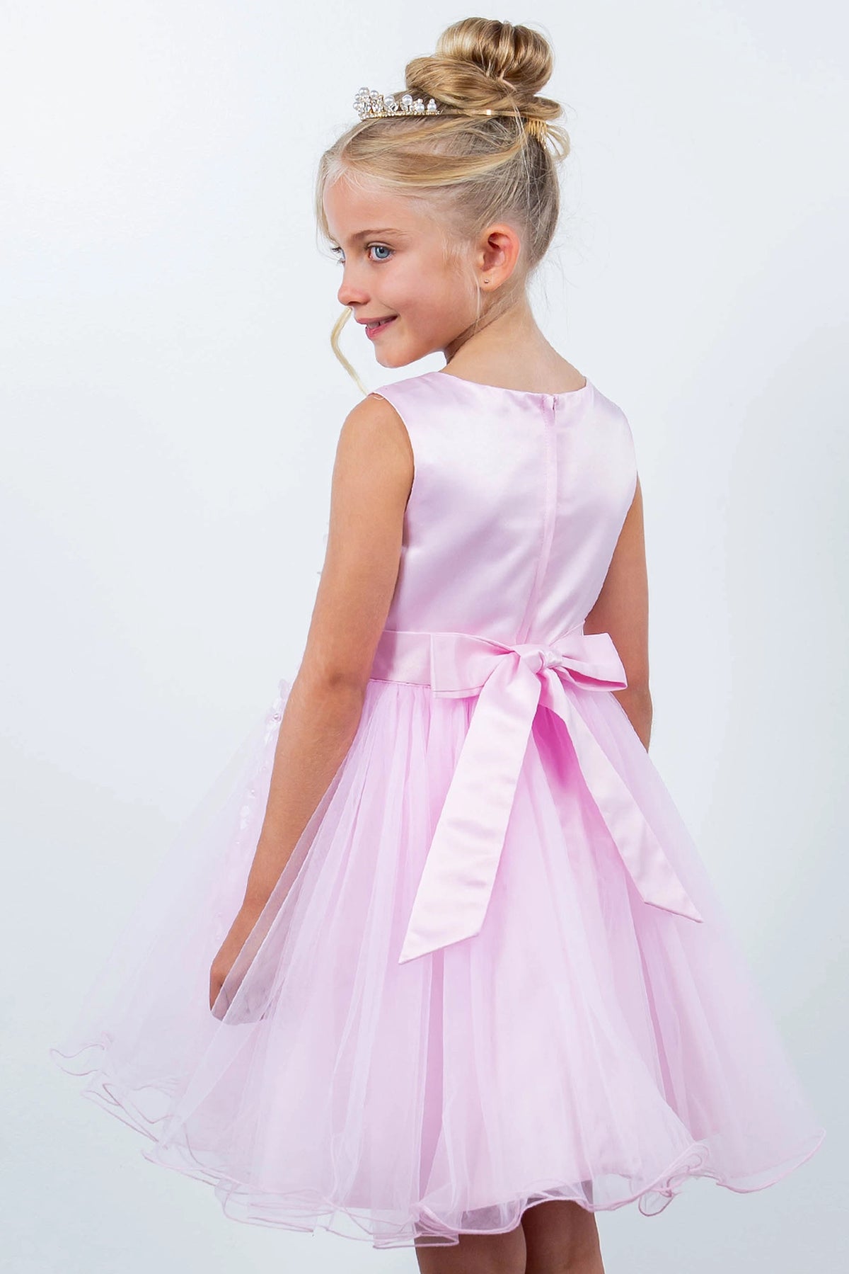 Finished details of a satin back bow distinguish the Pink kids party dress.