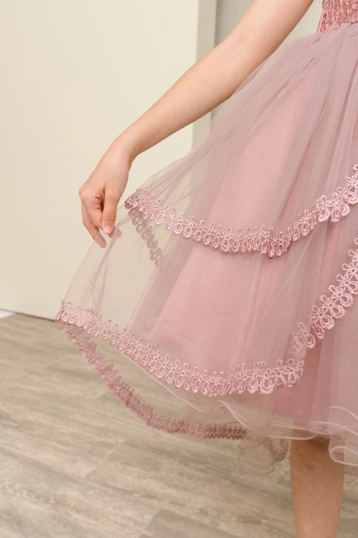 Details of the Mauve flower girl dress include scalloped lace trim on the tulle tiers.