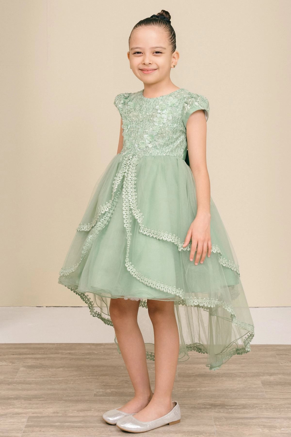 Featuring scalloped lace edging along the high-low tiers on the Sage flower girl dress.