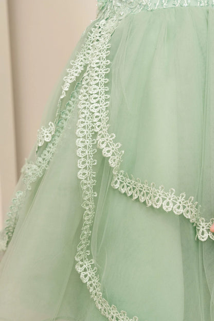 Details of the Sage flower girl dress include scalloped lace band at the skirt tier.