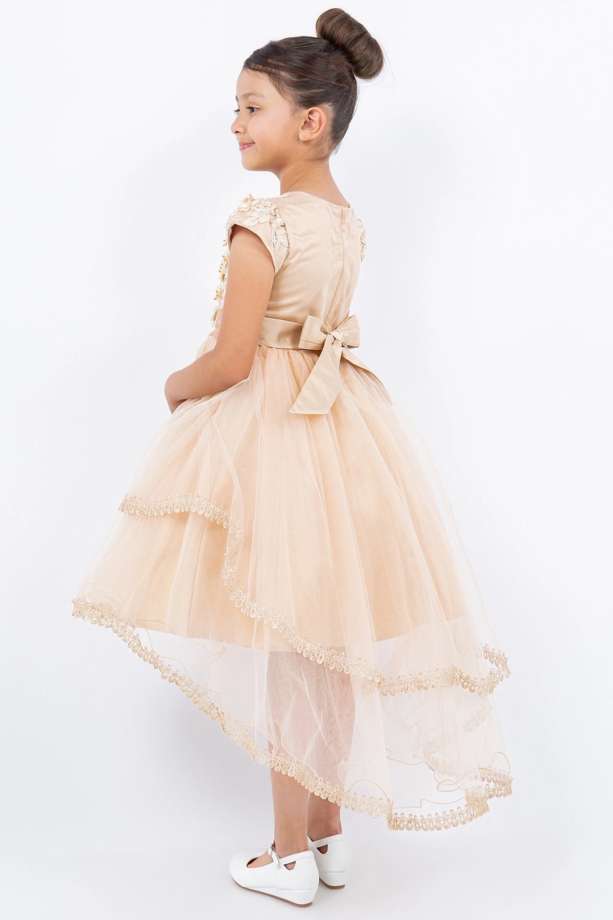 Details of the Taupe flower girl dress include lace-edged tiers below the fitted waist.