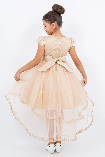 A Taupe flower girl dress showing satin bow and longer hem at the back.